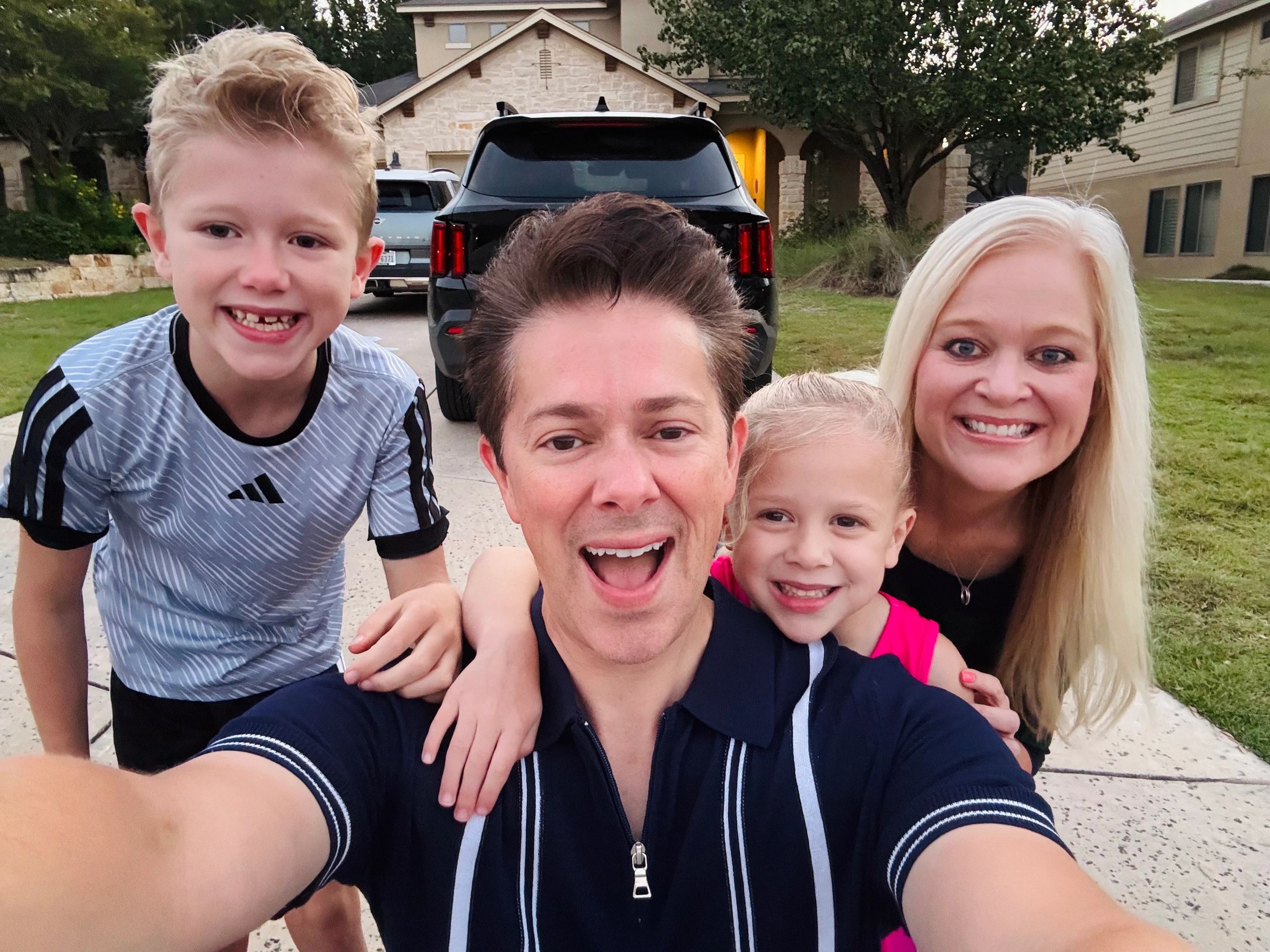 Family smiling together on a sunny day