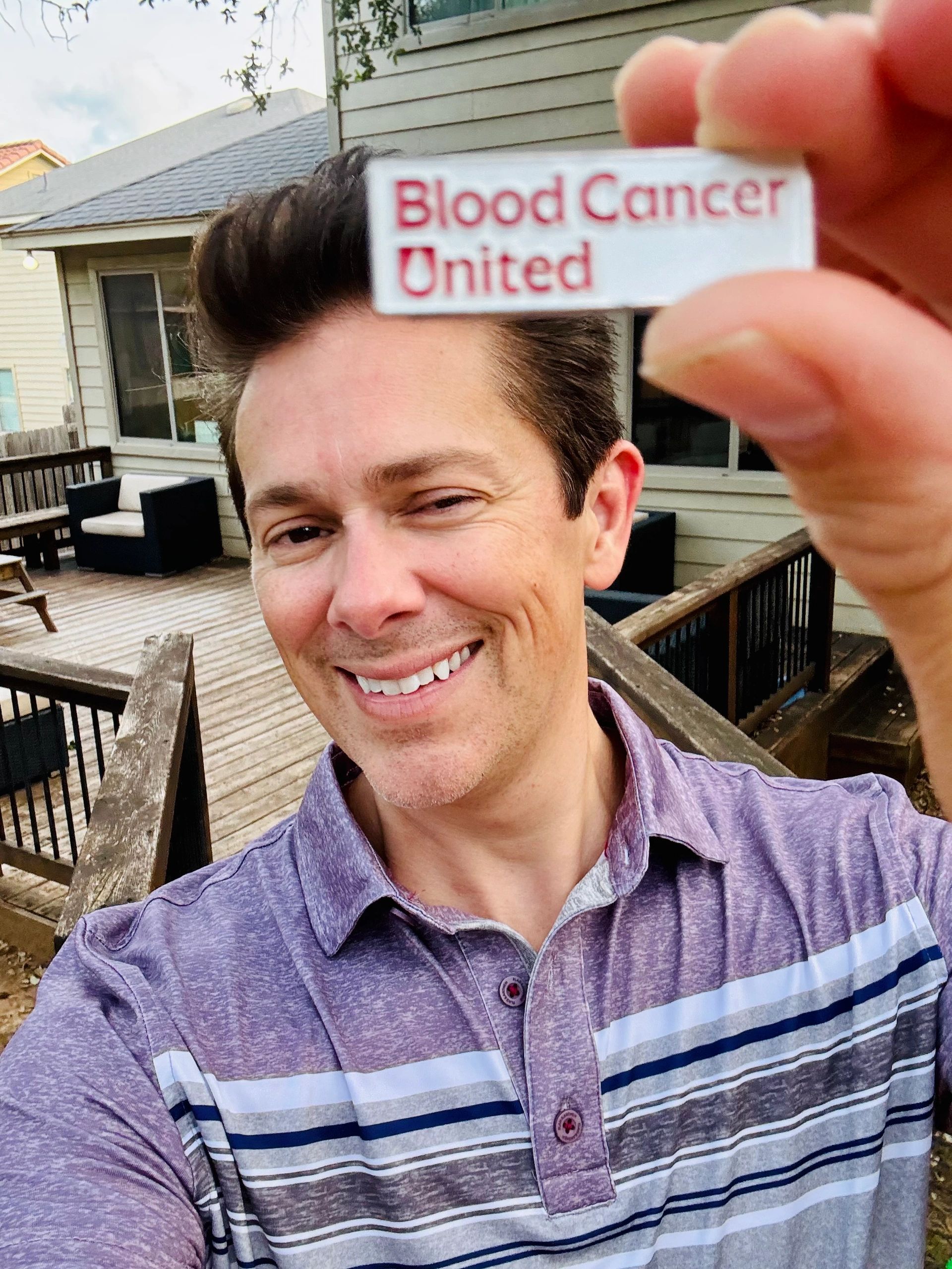 Alan holding Blood Cancer United card